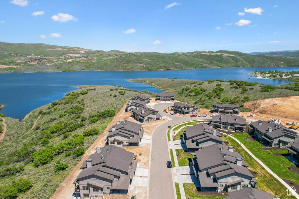 Birds eye view of property featuring a water and mountain view