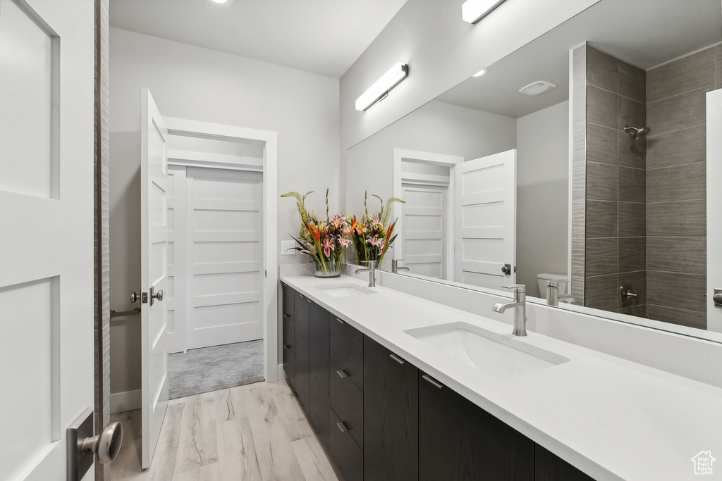 Bathroom featuring hardwood / wood-style floors and double vanity