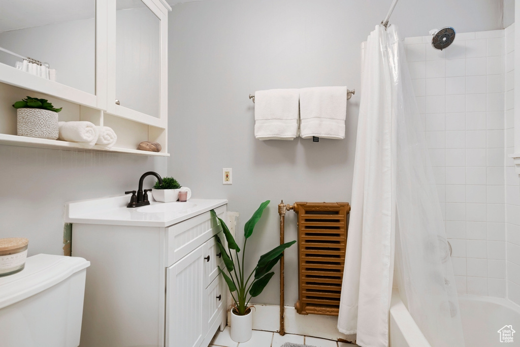 Full bathroom featuring shower / bath combination with curtain, toilet, tile patterned floors, and vanity