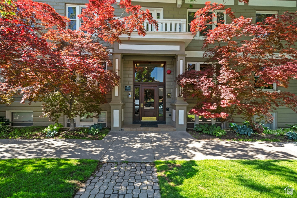 Doorway to property with a yard