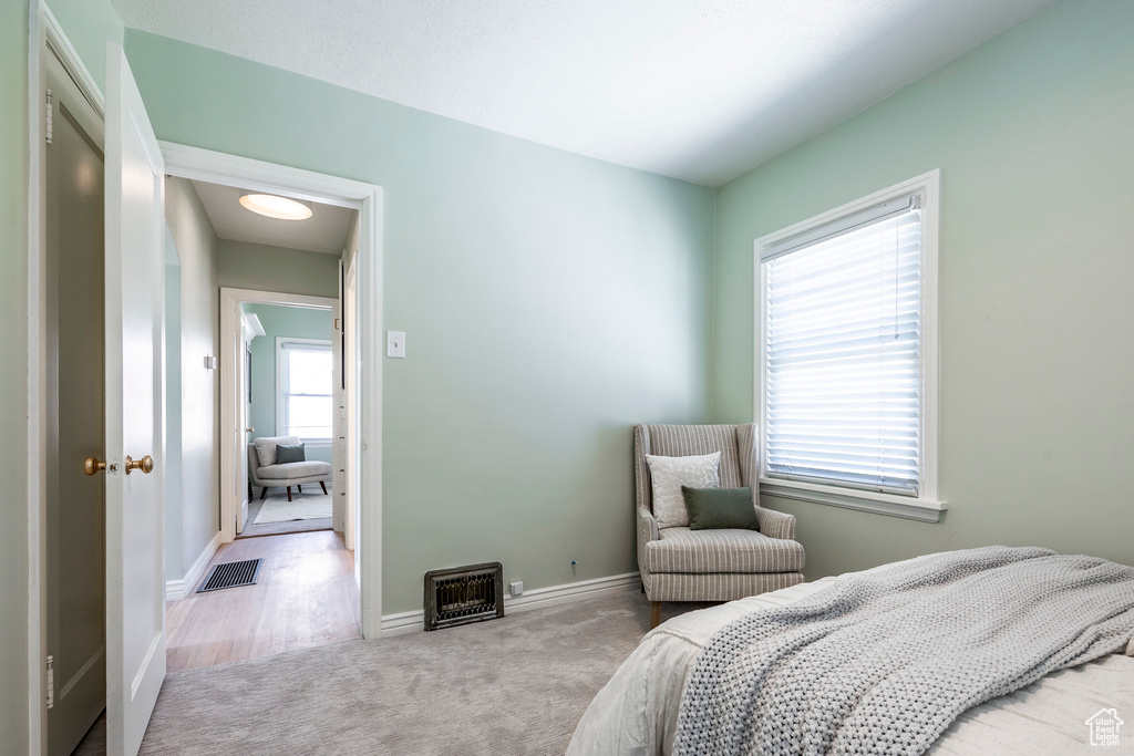 Bedroom featuring light colored carpet