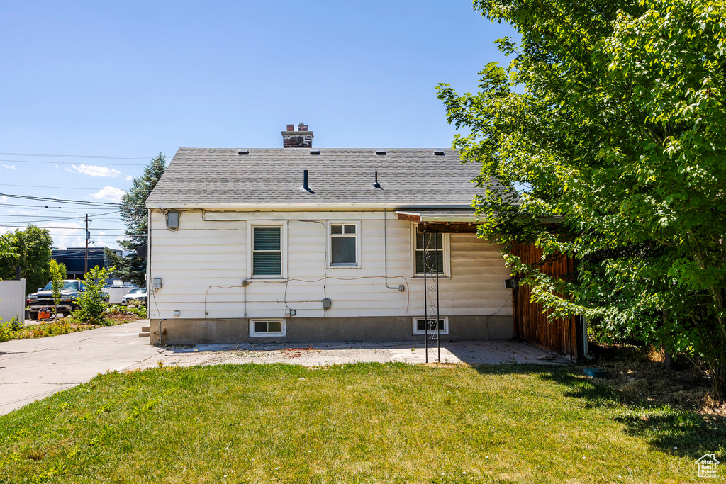 Rear view of house with a lawn