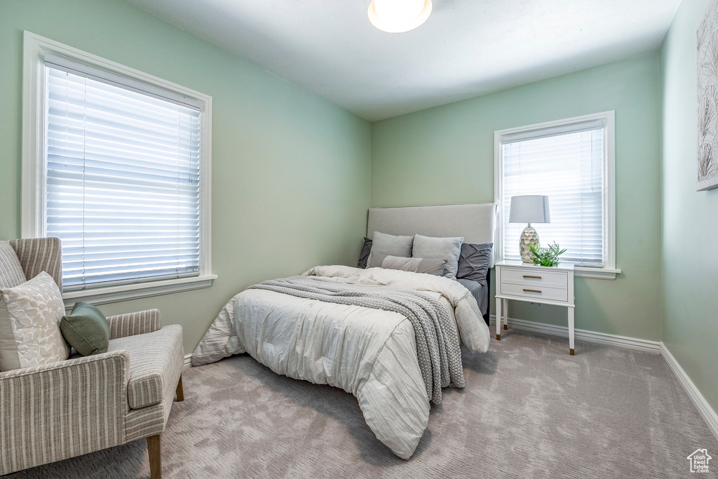 Bedroom featuring light carpet