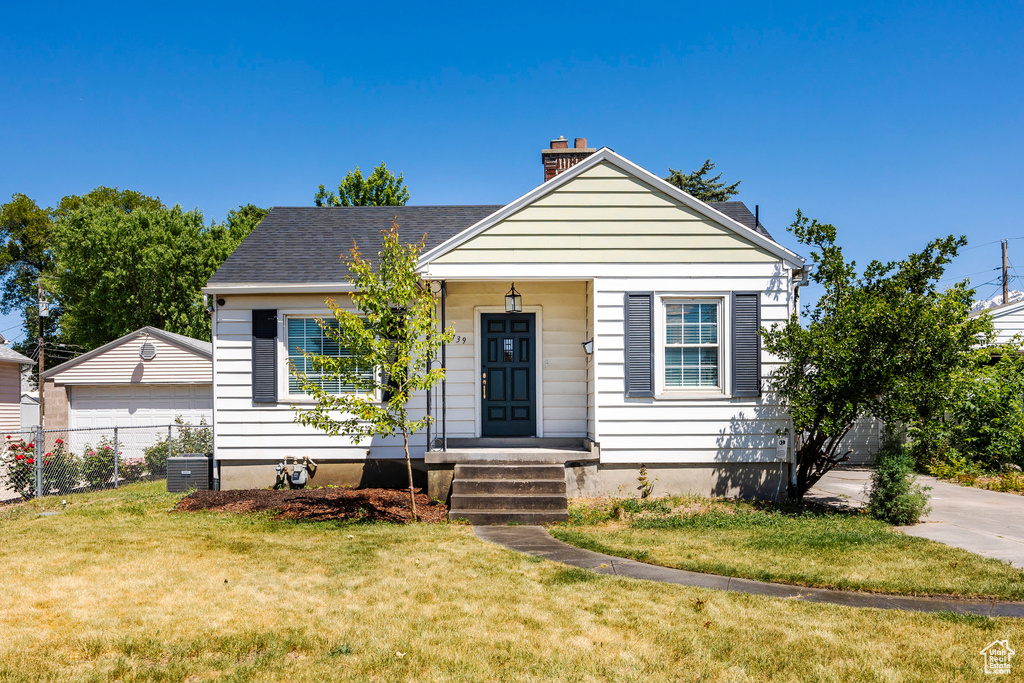 Bungalow-style house featuring a front yard