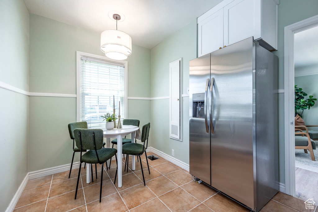 Dining area featuring light tile patterned floors