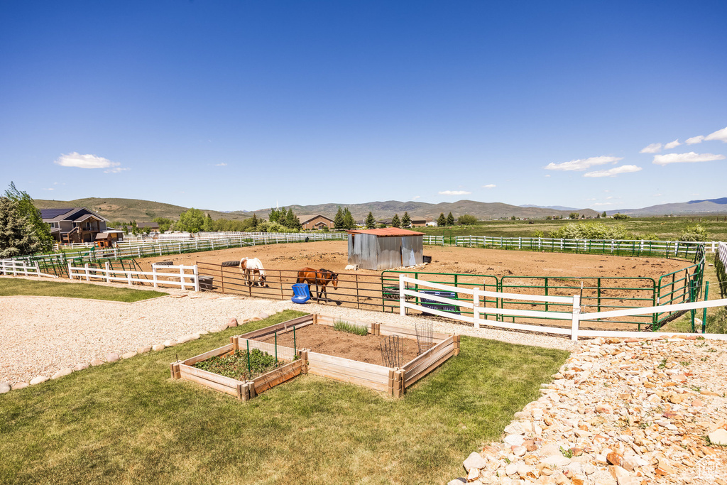 View of yard featuring a mountain view, an outdoor structure, and a rural view