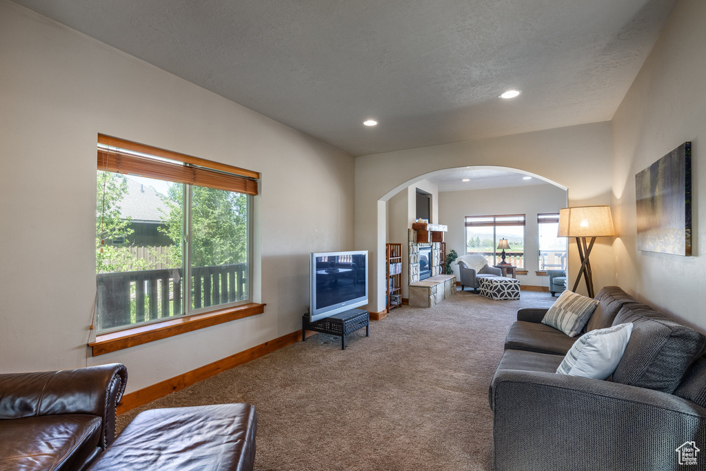 Carpeted living room with a fireplace