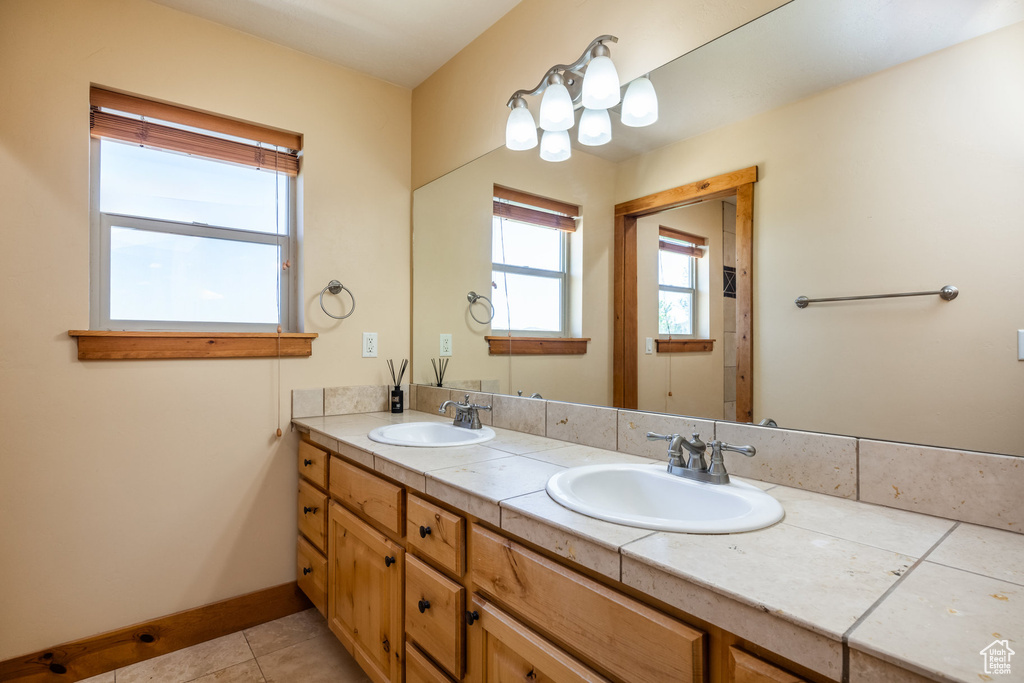 Bathroom with double vanity and tile patterned floors