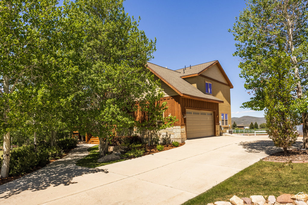 View of front of house featuring a garage and a mountain view