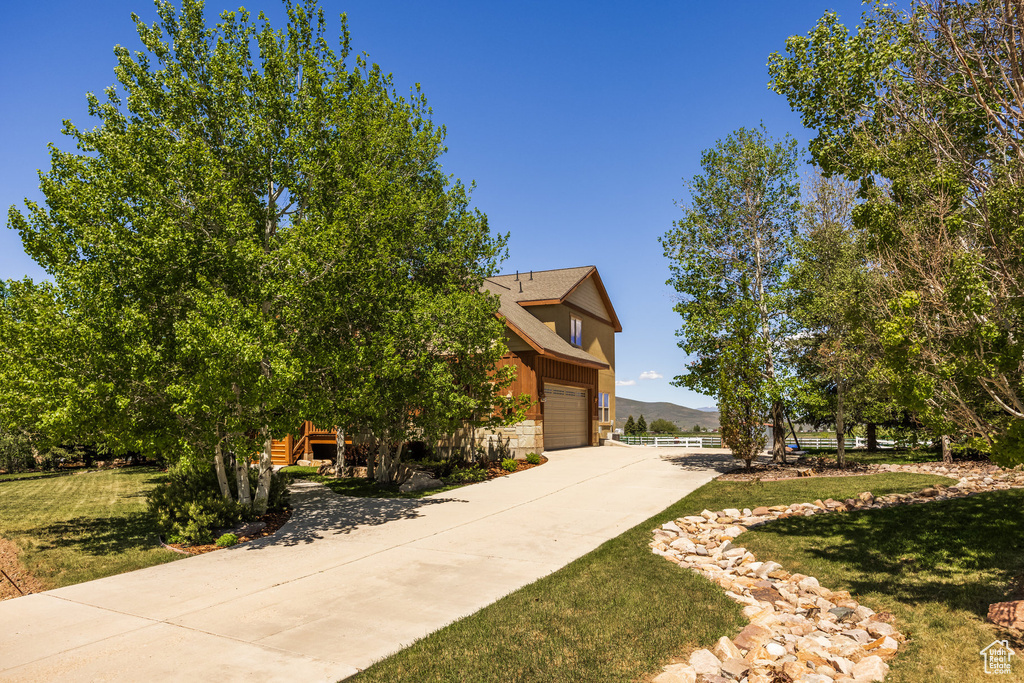 Exterior space with a garage and a front yard