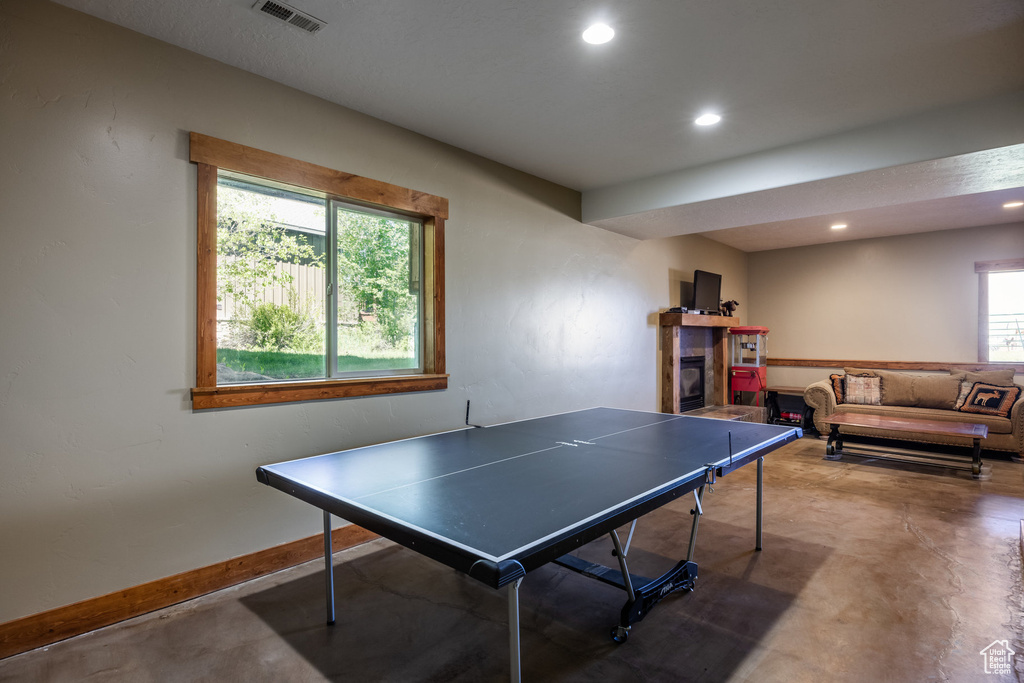 Rec room featuring plenty of natural light and concrete flooring