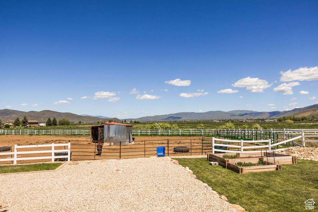 View of stable with a mountain view and a rural view