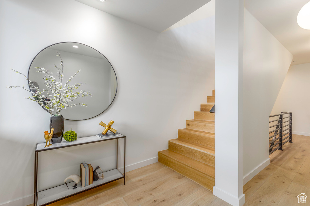 Staircase featuring wood finished floors and baseboards
