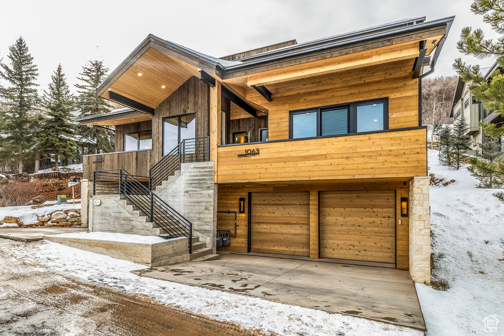 Modern home with an attached garage and stairway