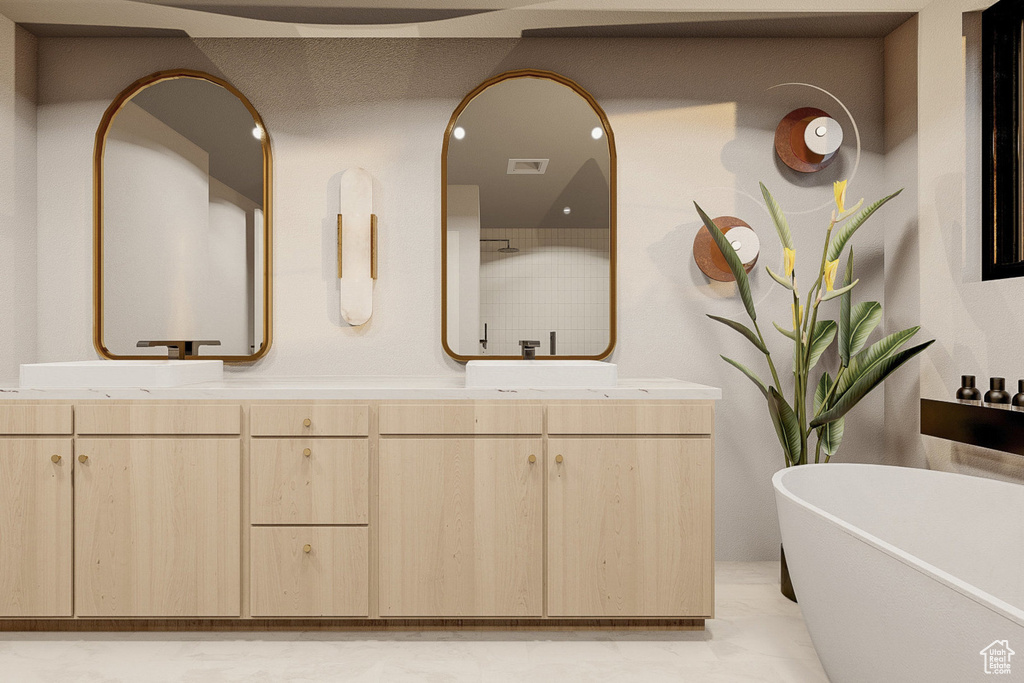 Bathroom with dual vanity, tile patterned floors, and a tub