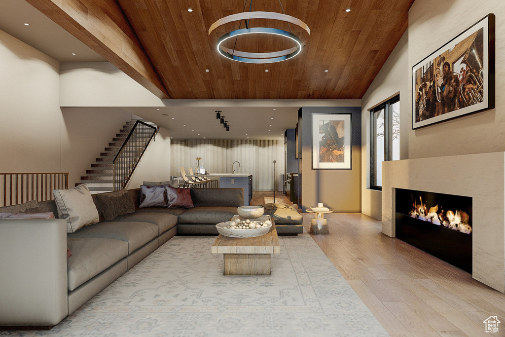 Living room featuring high vaulted ceiling, light wood-type flooring, and wooden ceiling