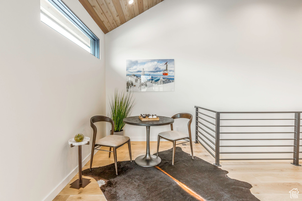 Living area with wooden ceiling, wood finished floors, baseboards, and lofted ceiling