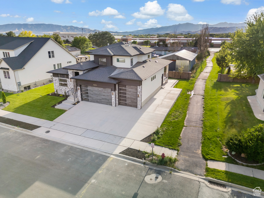 Exterior space with a mountain view and a front yard