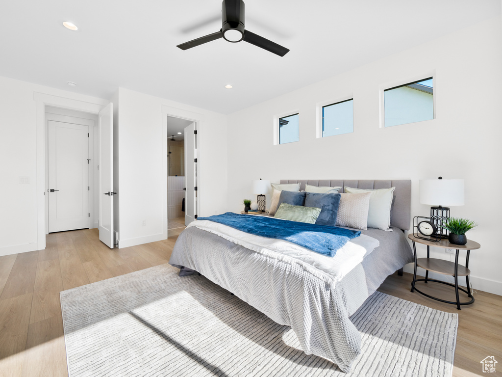 Bedroom with ceiling fan and light wood-type flooring