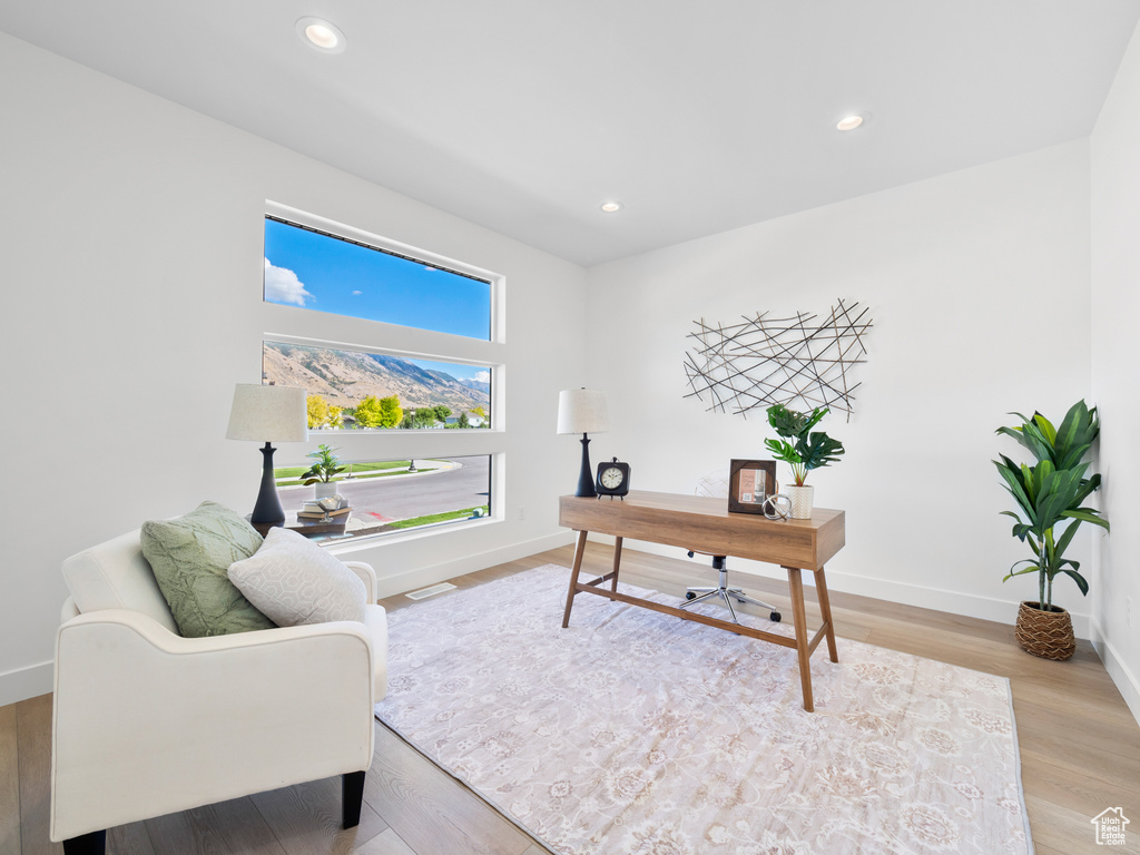 Home office with light wood-type flooring