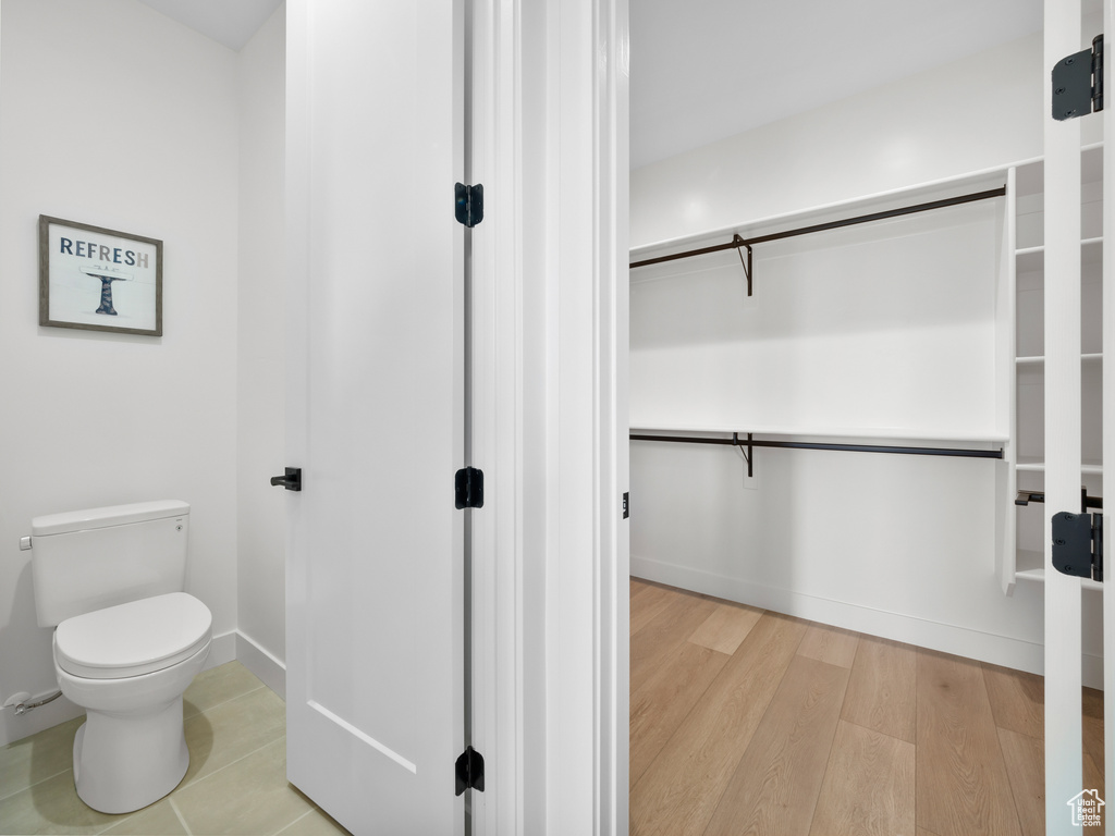 Bathroom featuring wood-type flooring and toilet