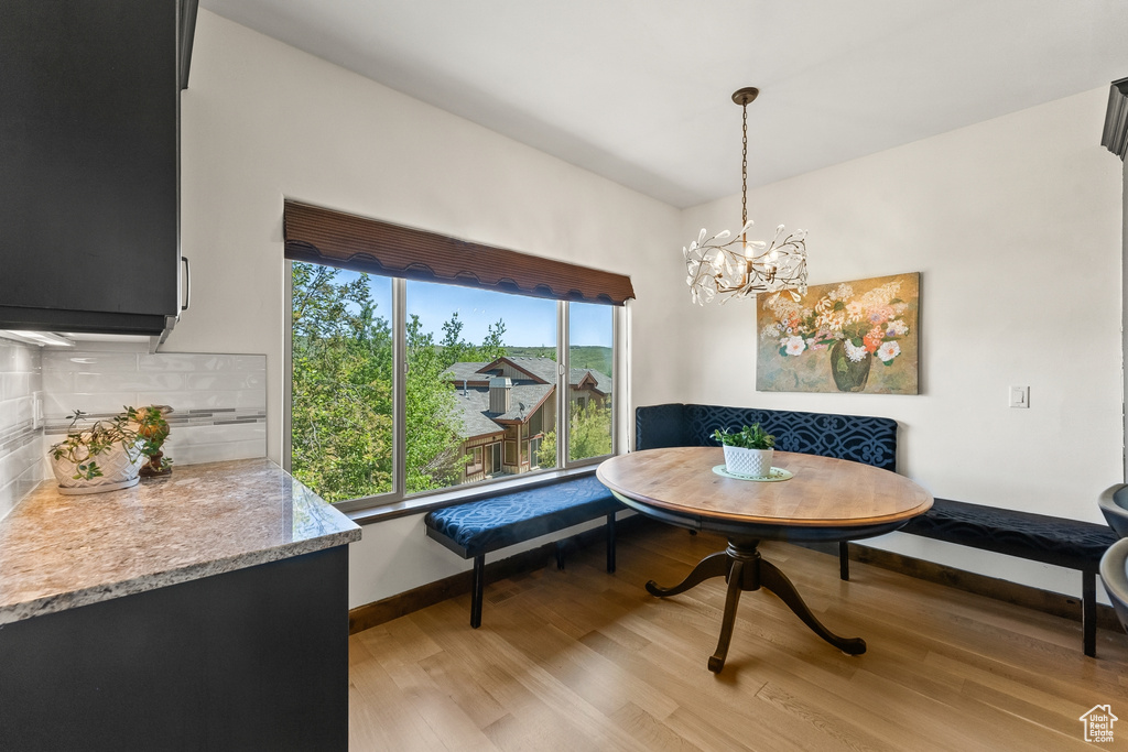 Dining space featuring a chandelier and light wood-type flooring