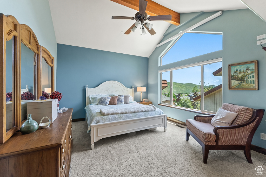 Bedroom featuring beamed ceiling, ceiling fan, carpet flooring, and high vaulted ceiling