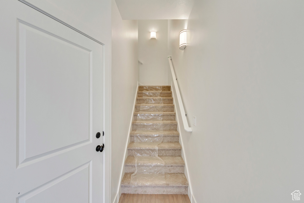 Stairway featuring hardwood / wood-style floors