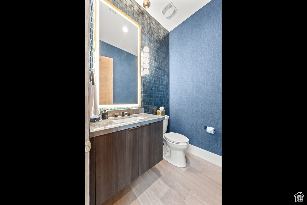 Bathroom with vanity, toilet, and tile patterned flooring