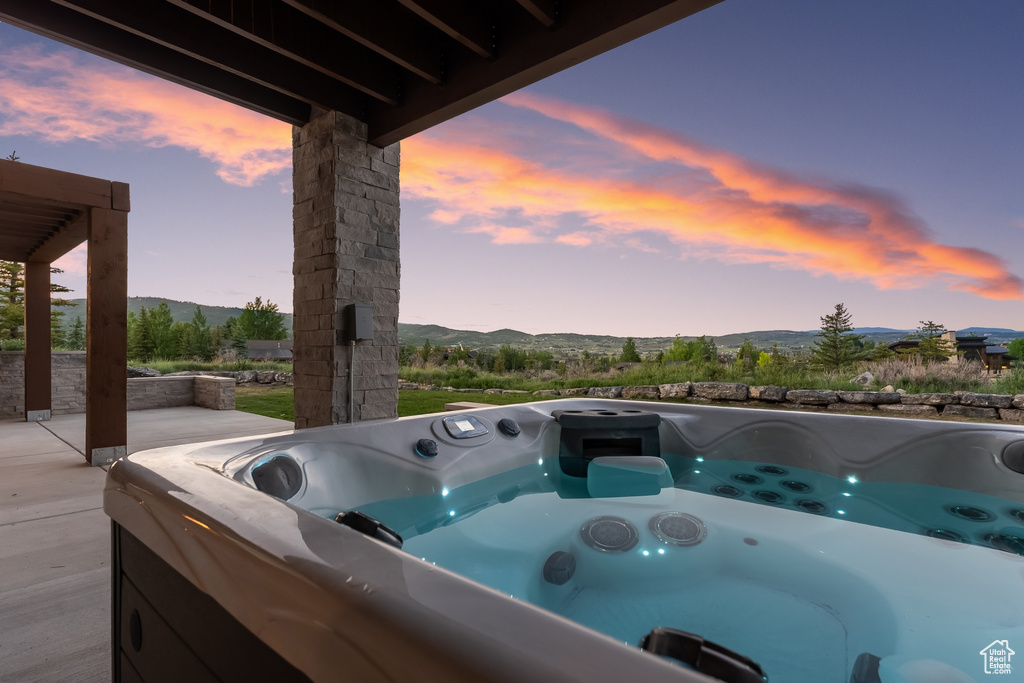 Patio terrace at dusk with a hot tub