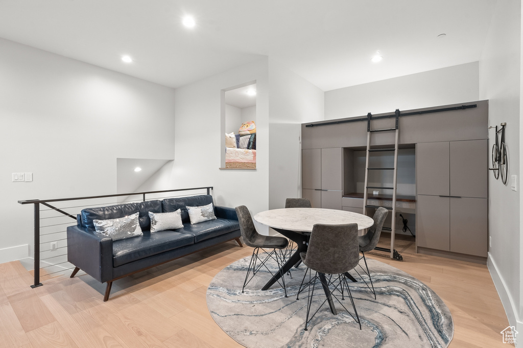 Dining space with light hardwood / wood-style flooring