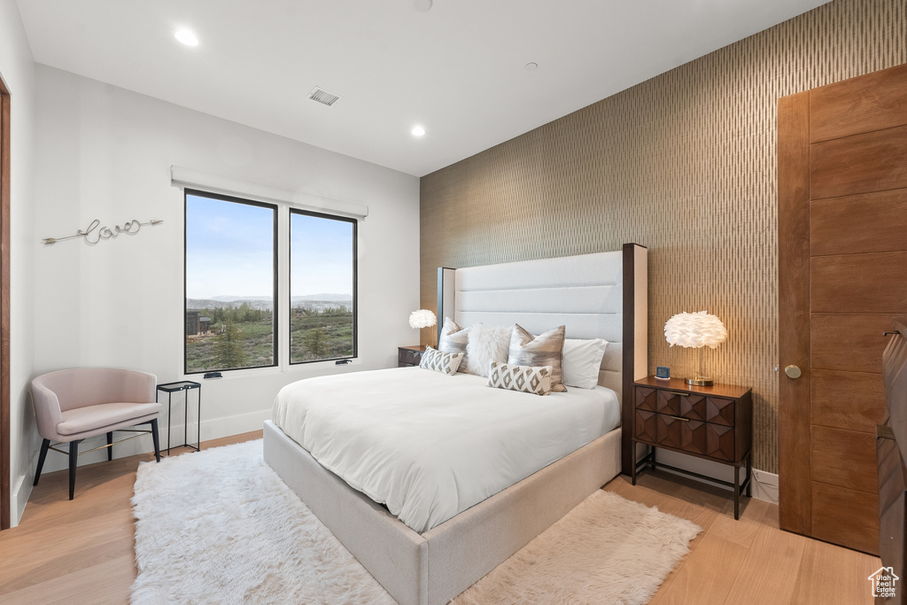 Bedroom with light hardwood / wood-style flooring