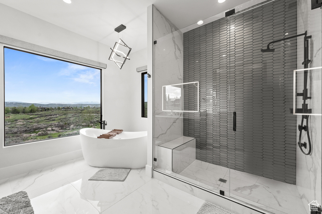 Bathroom with tile patterned flooring and independent shower and bath