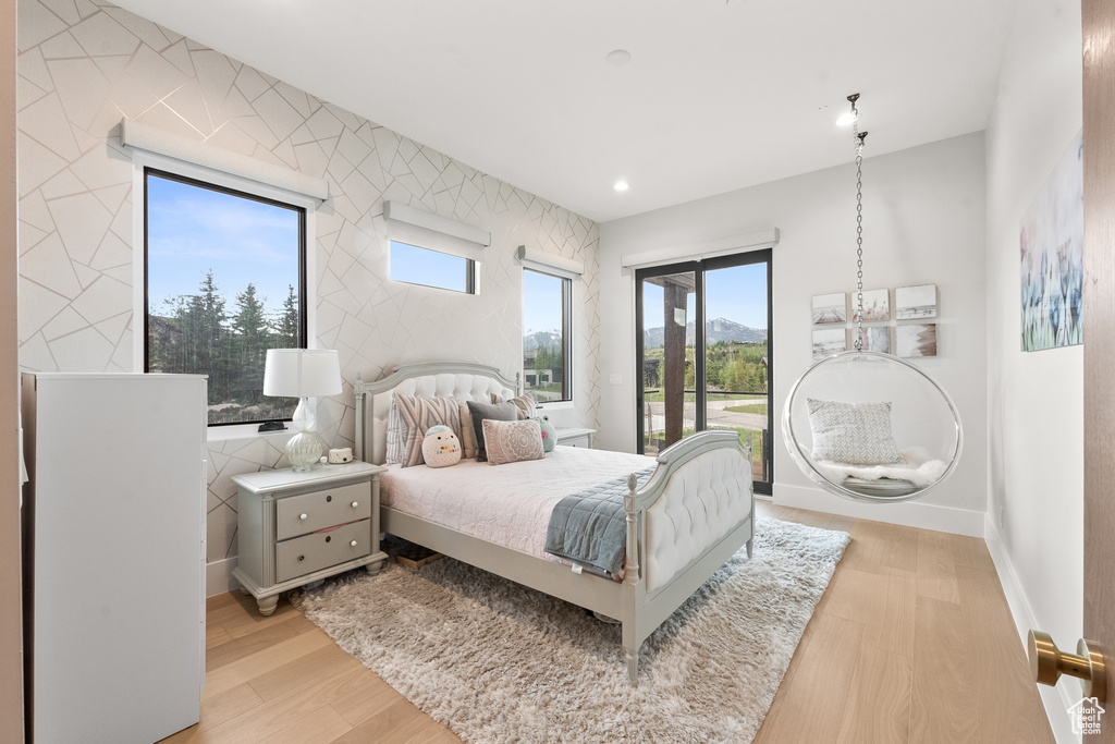 Bedroom with access to outside and light hardwood / wood-style flooring