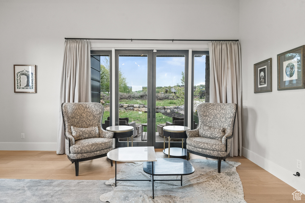 Sitting room with light hardwood / wood-style flooring and plenty of natural light