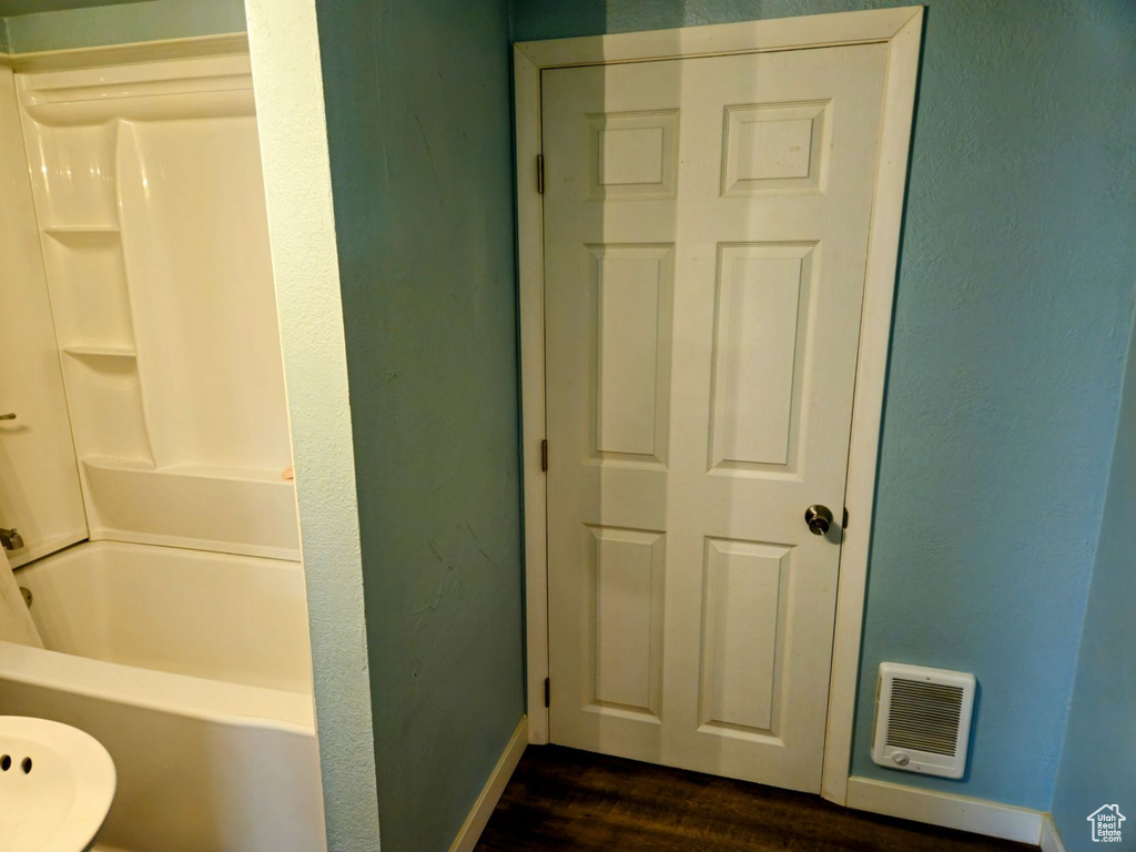 Bathroom with  shower combination and wood-type flooring