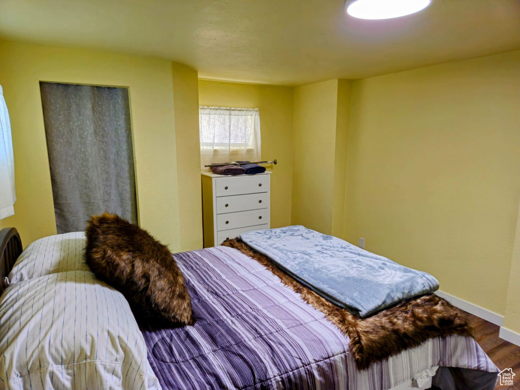 Bedroom with hardwood / wood-style floors