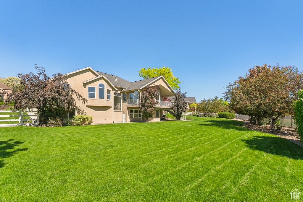 Back of house featuring a lawn