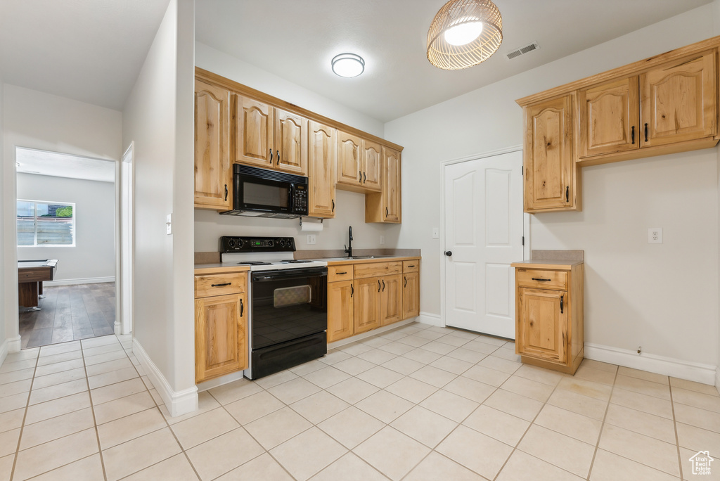 Kitchen featuring sink, billiards, electric stove, and light tile flooring