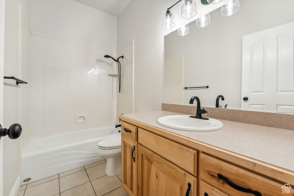 Full bathroom featuring shower / bath combination, tile flooring, vanity, and toilet