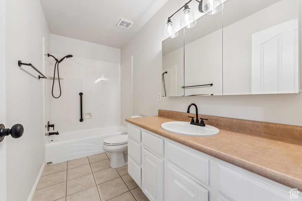 Full bathroom featuring tile flooring, bathtub / shower combination, vanity, and toilet