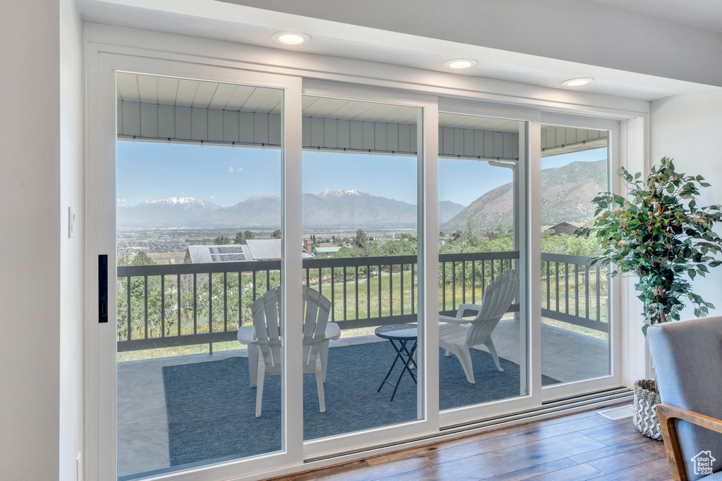 Entryway with a wealth of natural light, dark hardwood / wood-style floors, and a mountain view