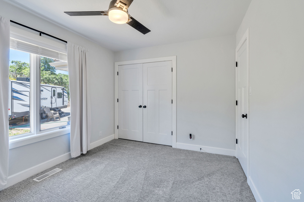 Interior space with ceiling fan and a healthy amount of sunlight