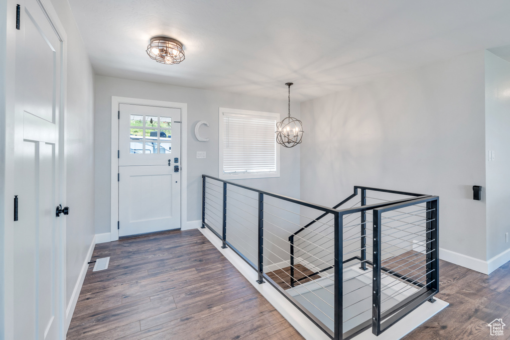 Foyer featuring dark hardwood / wood-style flooring and a chandelier