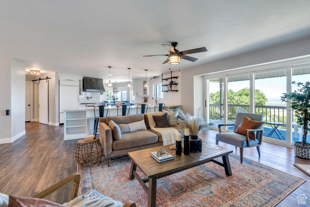 Living room with hardwood / wood-style floors and ceiling fan