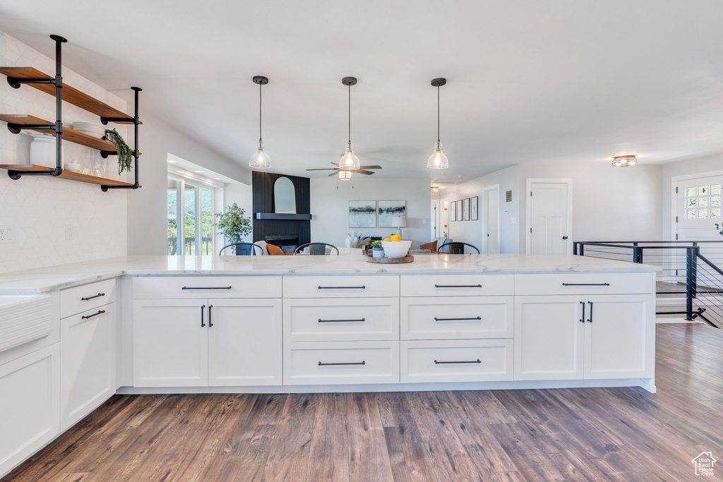 Kitchen featuring dark wood-type flooring, white cabinetry, and ceiling fan