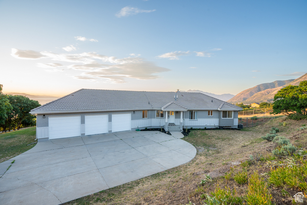 Ranch-style home featuring an outdoor structure, a garage, and a mountain view