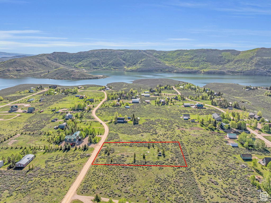 Drone / aerial view with a water and mountain view