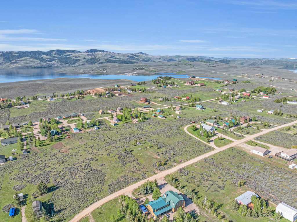 Drone / aerial view featuring a water and mountain view