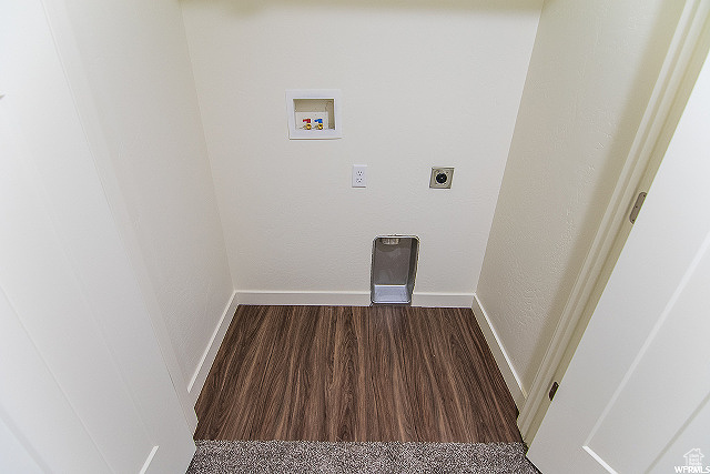 Laundry area featuring dark wood-type flooring, hookup for a washing machine, and hookup for an electric dryer